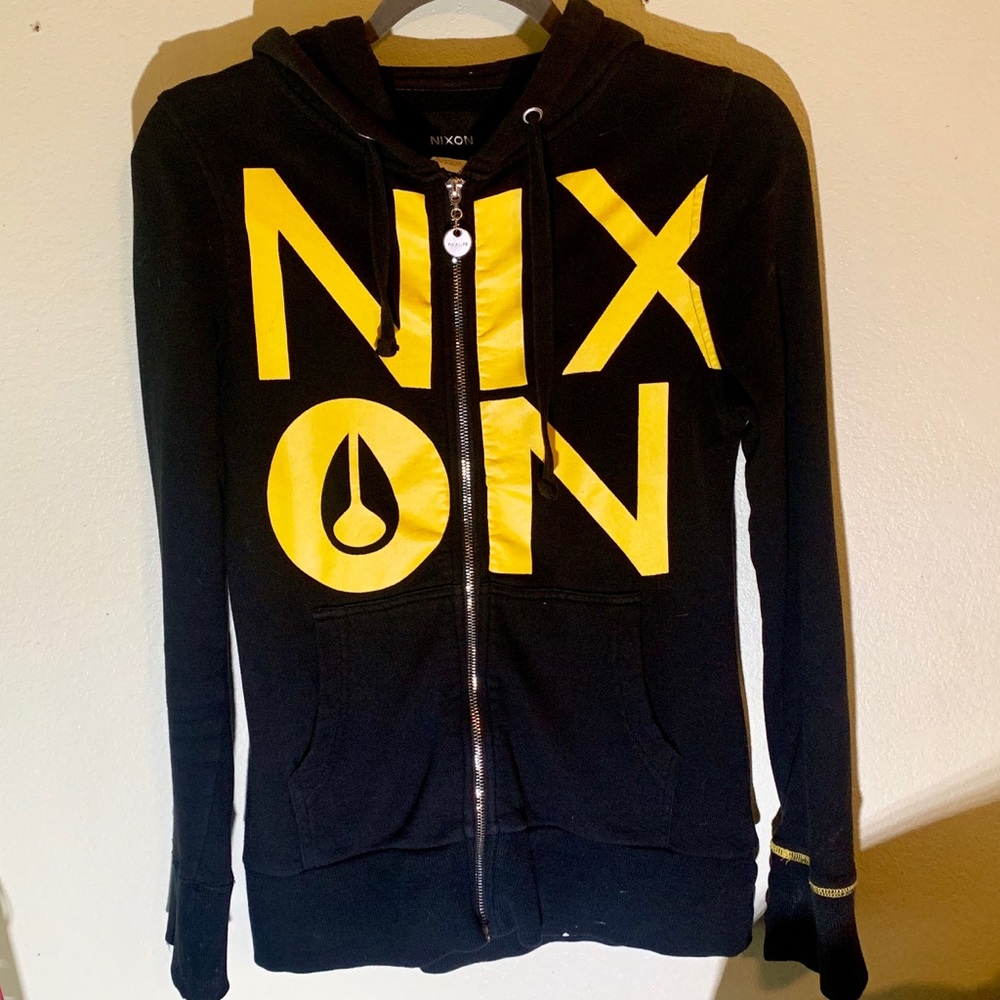 Nixon black zip-up hoodie w/yellow “Nixon” letters